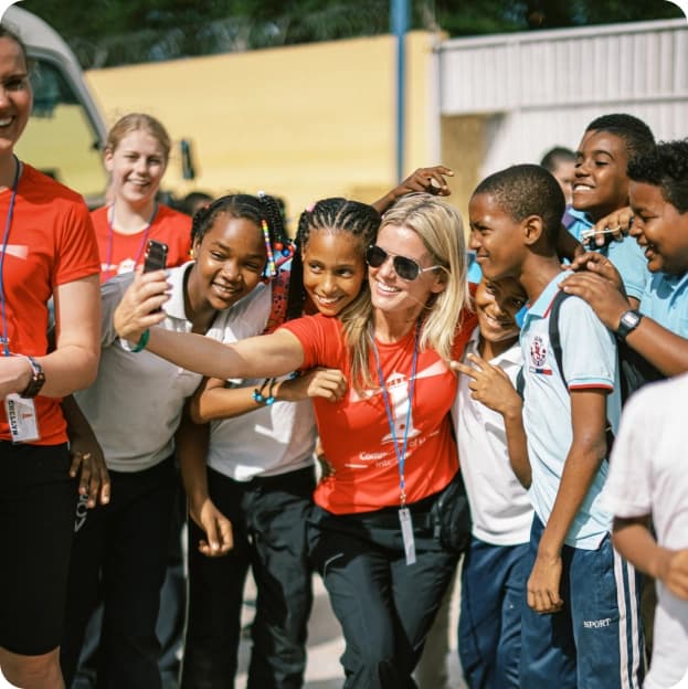 Group of volunteers and students taking a selfie together